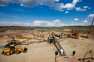 cone crusher actively working on a quarry with conveyor belts