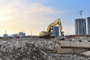 An excavator and concrete debris on a construction site