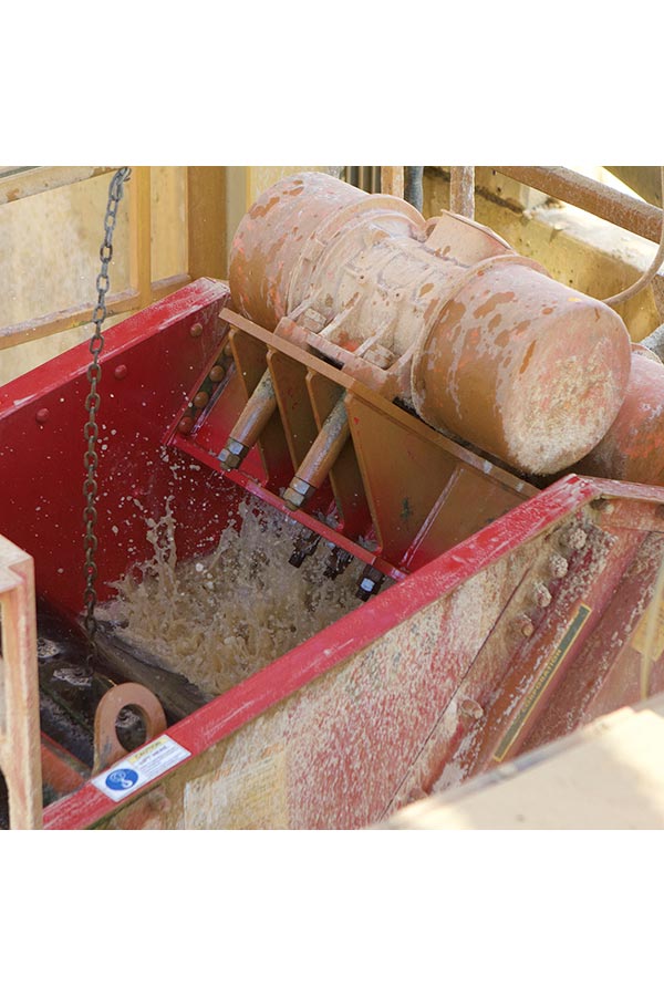 red dewatering screens machine actively working on a site