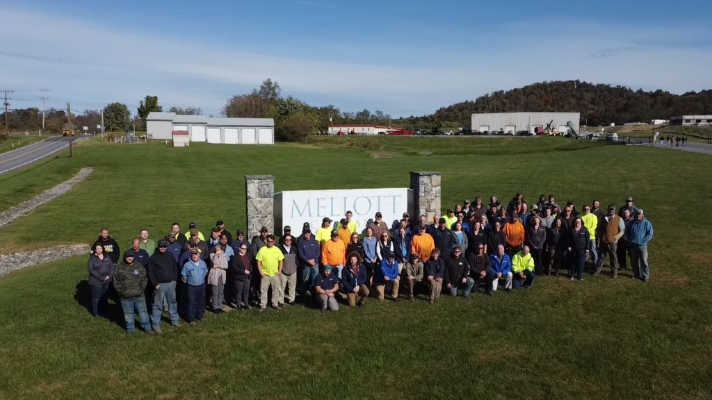 Mellot employees standing in front of the company sign