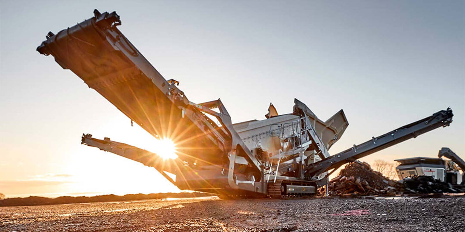 rock crusher on a site during sunset
