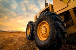 rubber wheels of soil grade tractor car earthmoving at road construction side