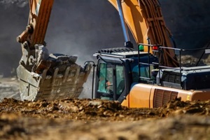 close view of an excavator breaking rocks in a quarry